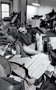 Chamberlain seated among his materials in his studio, 53 Greene Street, 1964
